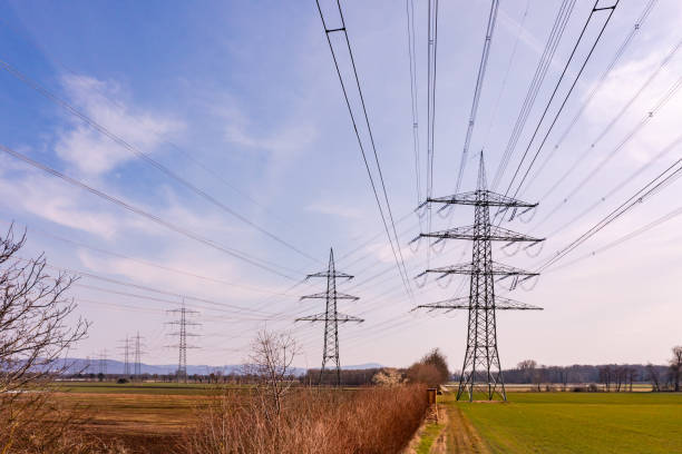 Aerial view directly under the power lines of many electricity pylons in the countryside, Germany stock photo
