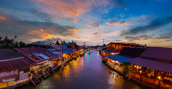 Samut Songkhram, Thailand - 25 June 2022: View of Amphawa Floating Market Towns and tourists walk shopping, eat and take pictures around the area. There are many restaurants in the area. Is one of the