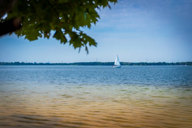 istock A beautiful lagoon with clear water. A lonely sailboat in the background. Sunny day. Holidays. Lake Dziekowice, Poland 1413630607