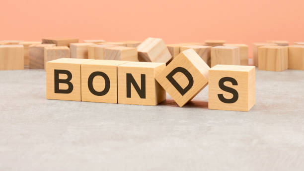 istock word Bonds made with wood blocks. text is written in black letters, light background 1413632483