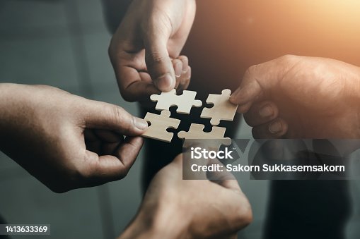 istock mobile jigsaw puzzle pieces business cooperation concept teamwork and cooperation Businessmen join a jigsaw team, charity, volunteerism, unity, teamwork. 1413633369