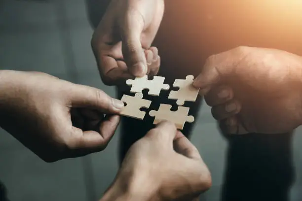 Photo of mobile jigsaw puzzle pieces business cooperation concept teamwork and cooperation Businessmen join a jigsaw team, charity, volunteerism, unity, teamwork.
