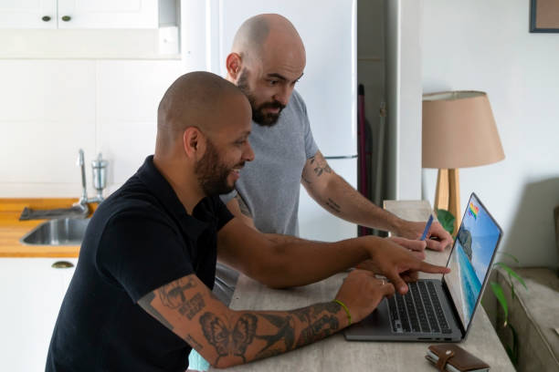 istock Men planing a trip with a laptop. 1413636654
