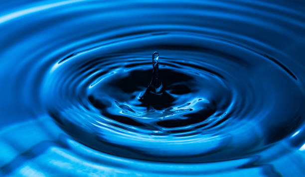 istock Macro water drop,The water droplets fall on the water surface until the water spread out, creating beautiful ripples on the light blue water 1413637942