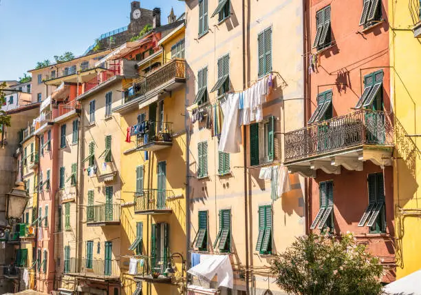 Laundry drying on clotheslines outside apartment windows in Riomaggiore, one of the 'Cinque Terre' towns in northern Italy's Liguria region.