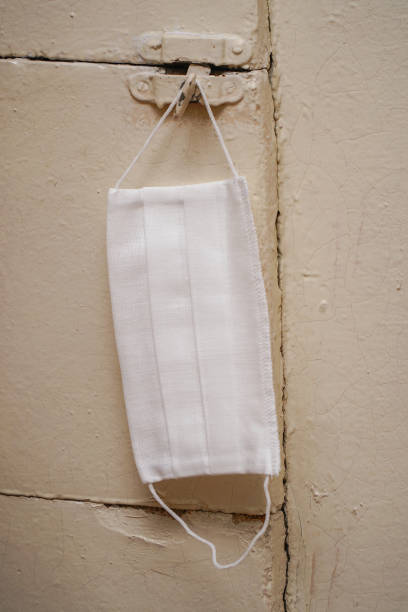 istock A protective medical mask hangs on dirty wall 1413639991