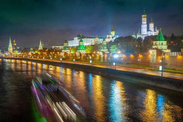 Kremlin towers illuminated at evening with river Moscva reflection, Moscow, Russia