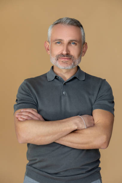 istock Confident man standing with his arms crossed 1413640912