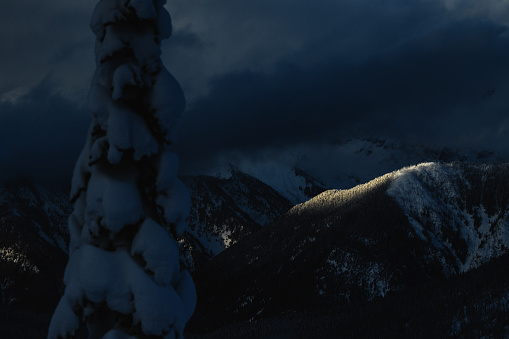 sliver of light on winter ridge line of selkirk mountains in Revelstoke, British Columbia, Canada
