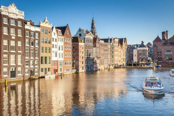 istock Amsterdam canal with boat and dutch architecture, Netherlands 1413643067