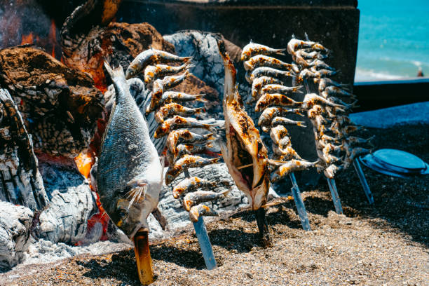 espetos being cooked in La Malagueta beach, Malaga stock photo