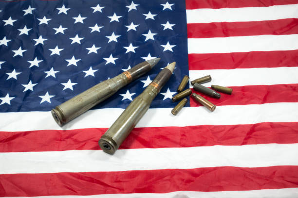 istock American flag with bullets, shells, cartridges and projectiles on it. Lend-Lease concept.  Army concept. Sales of weapons and ammunition. Military industry, war, global arms trade. 1413643877