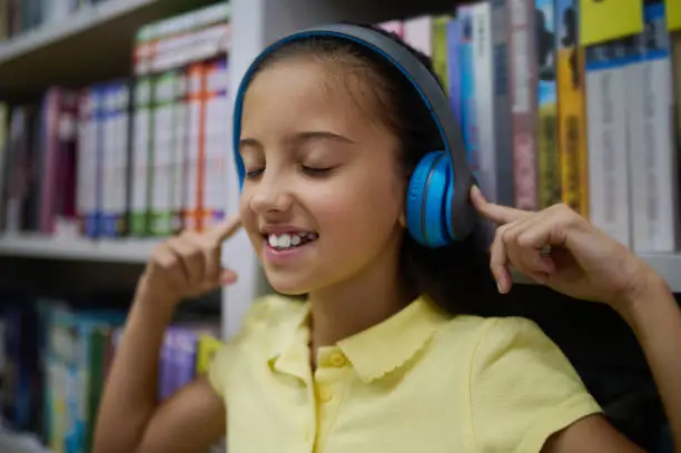 Photo of Modern young lady enjoying her favorite song