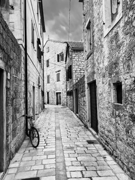 Bicycle leaning against a city wall in Italy