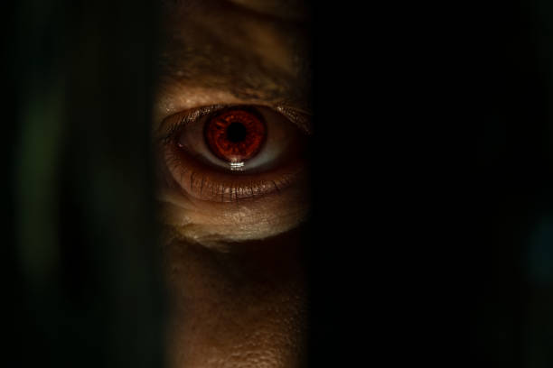 Eye Close up of male eye looking through the hole cruel stock pictures, royalty-free photos & images