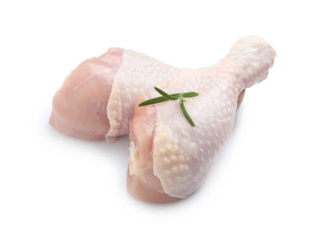 istock Raw chicken drumsticks with rosemary on white background 1413648271