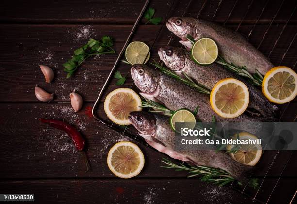 Raw Rainbow Trout With Lemon And Herbs On A Wooden Table No People Stock Photo - Download Image Now