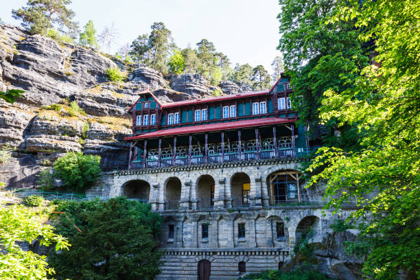 House between rocks near Pravcicka Gate. Hrensko, Czech Republic, 18 May 2022 House between rocks near Pravcicka Gate. Hrensko, Czech Republic, 18 May 2022. pravcicka stock pictures, royalty-free photos & images