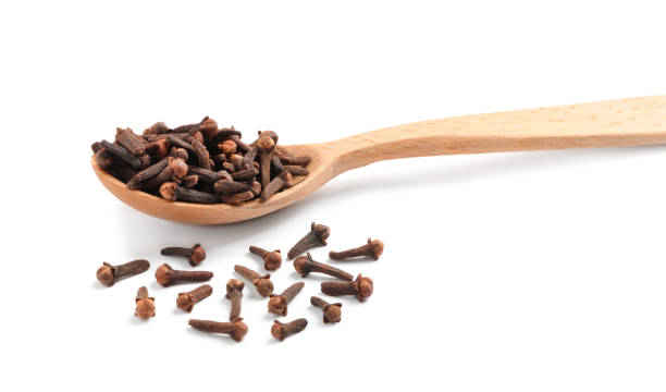 istock Aromatic dry cloves and wooden spoon on white background 1413649525