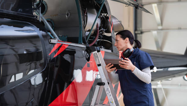 istock Female Aero Engineer Working On Helicopter In Hangar 1413650425