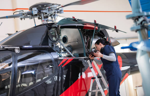istock Female Aero Engineer Working On Helicopter In Hangar 1413650437