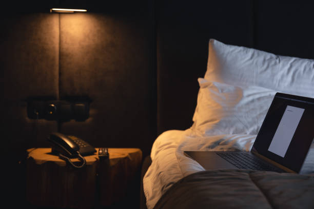 istock Laptop on bed at night in room interior. 1413650501