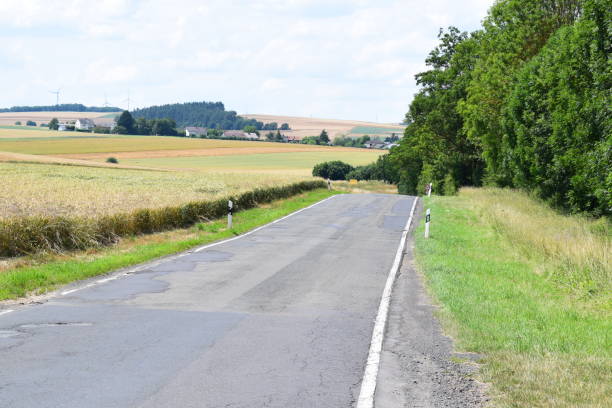 istock bad road with cracks and holes 1413651164