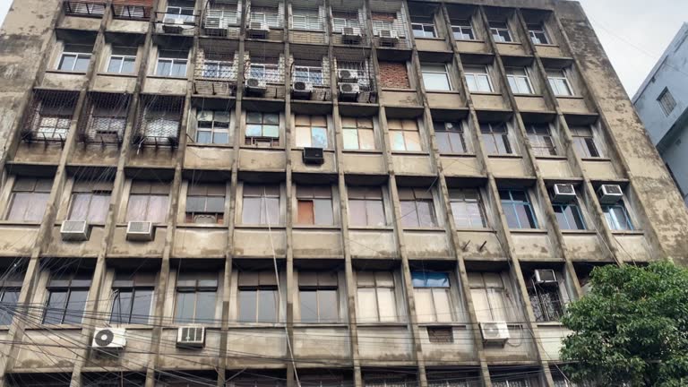 Video of old building with multiple windows and AC vents In Kolkata. India