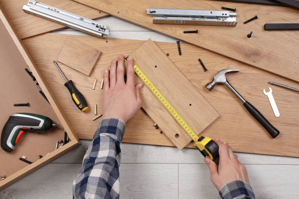 istock Man assembling wooden furniture on floor, top view 1413653415