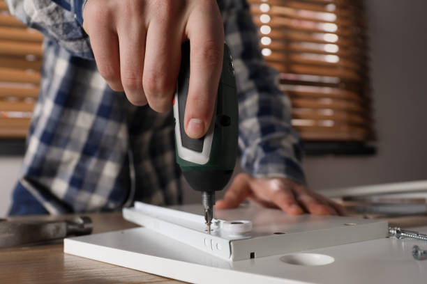 istock Man assembling furniture at table indoors, closeup 1413653440