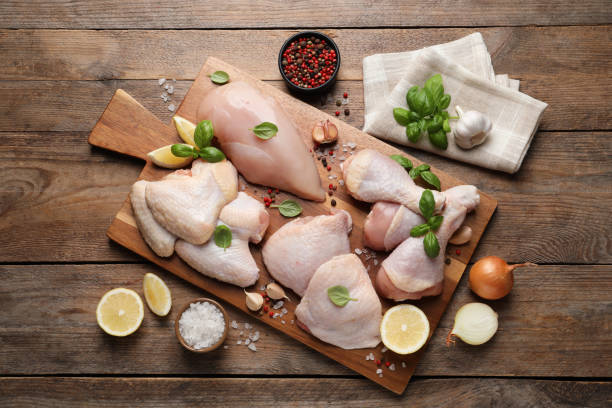 flat lay composition with fresh raw chicken meat on wooden table - poultry imagens e fotografias de stock