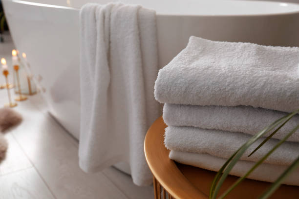 istock Fresh clean terry towels on table in bathroom. Space for text 1413653607