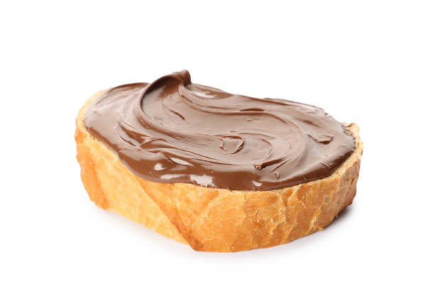 istock Bread with tasty chocolate spread on white background 1413653649