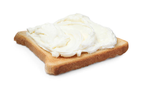 istock Slice of bread with tasty cream cheese isolated on white 1413653665