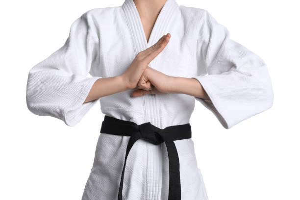 istock Martial arts master in keikogi with black belt on white background, closeup 1413653666