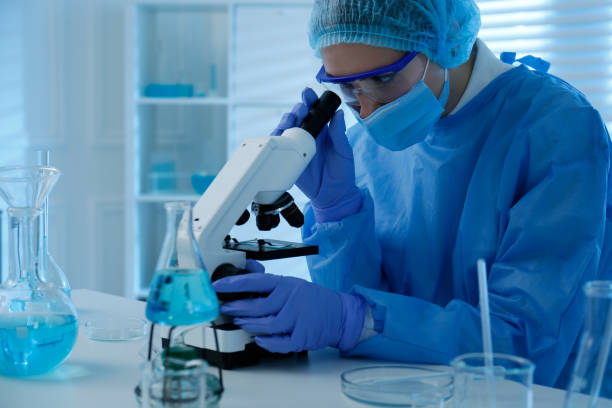 istock Scientist working with microscope in laboratory. Medical research 1413653740