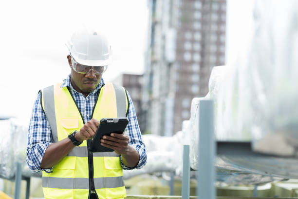 istock Male engineer or male technician work with digital tablet at construction site area. African American male engineer worker check or maintenance pipe system for ventilation and air conditioning 1413654384