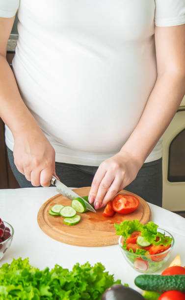 istock Pregnant Woman Chopping Vegetable 1413654505