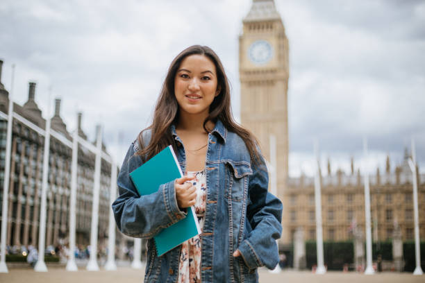 Happy Asian female student in London Happy female student in London exchange student stock pictures, royalty-free photos & images