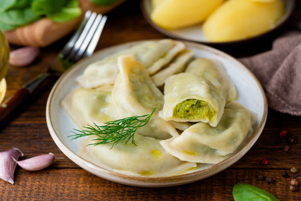 istock Ukrainian or polish dumplings, pierogi stuffed with potato and spinach mash 1413654814