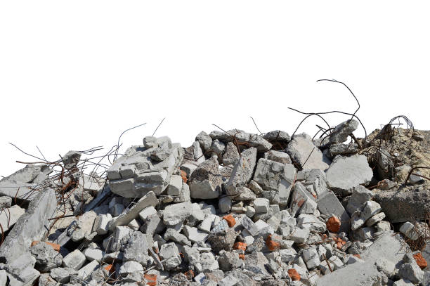 gray concrete fragments of the remains of a building with protruding fittings in sunlight, isolated on a white background. the concept of destruction. background. - demolishing destruction demolished built structure imagens e fotografias de stock