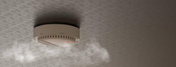 istock Smoke detector mounted on roof in apartment. 3d rendering 1413656479