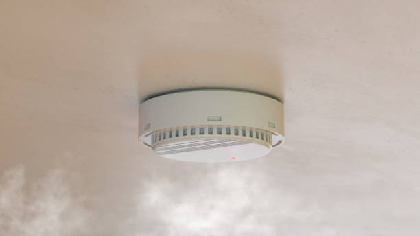 istock Smoke detector mounted on roof in apartment. 3d rendering 1413656489