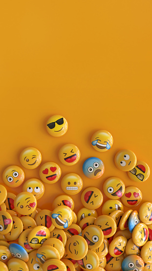 Vertical shot of a bunch of emojis with faces representing different emotions. 3d rendering.