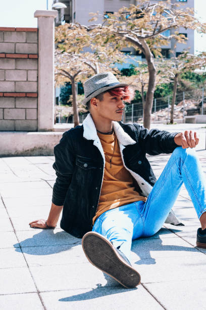 istock Man Sitting On Floor On Sunny Day 1413659284
