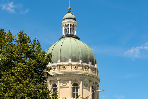 The Indiana Statehouse capitol building with blue sky behind.  Indiana, USA.