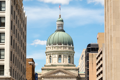 The Indiana Statehouse capitol building with blue sky behind.  Indiana, USA.