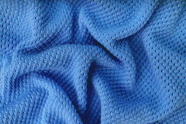 Photo of Bright blue knitwear wool fabric texture background. Abstract textile backdrop