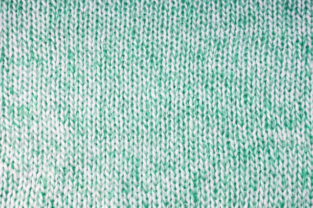 Photo of Bright green knitwear wool fabric texture background. Abstract textile backdrop