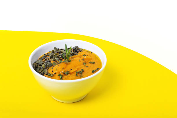 Homemade pumpkin cream soup bowl background